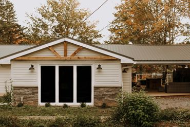 Cottage with white and brick exterior 