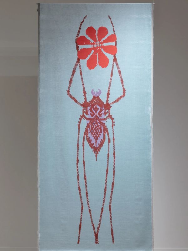 Two textile artworks featuring stylized animal and insect designs in a gallery space.