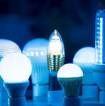 Several illuminated LED lightbulbs arranged in an upright position. The image has a blueish tinge ef
