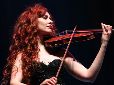 Tara McNeill, of Celtic Woman, playing her violin on tour in Cedar Falls, IA