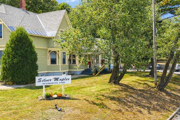 A residential care home named Silver Maples with autumn decorations outside.
