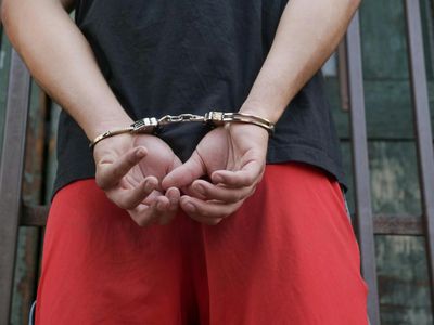inmate in silver handcuffs