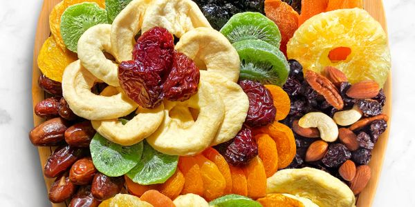 A colorful platter of assorted dried fruits and nuts.