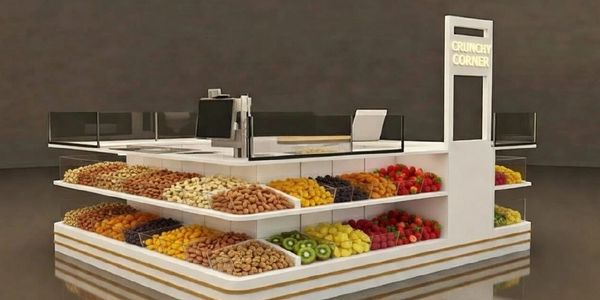 A modern kiosk named Crunchy Corner displaying various nuts and dried fruits.