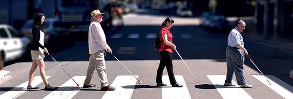 Four people walk across zebra crossing with a similar look to the famous Beatles album cover Abbey R