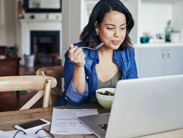 eating lunch while on laptop computer
eating
learning 
at home