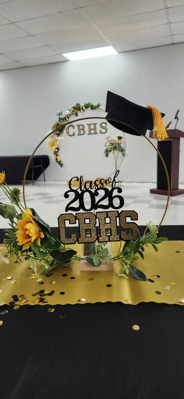 Graduation centerpiece for CBHS Class of 2026 with flowers and a cap.