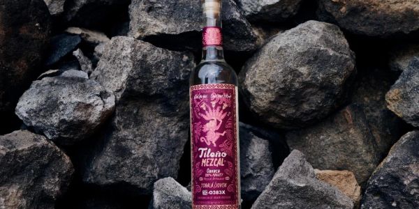 Bottle of Tilona Mezcal on rocks.