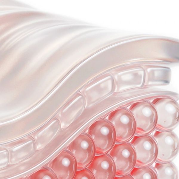 Close-up of a transparent, pink-tinted textured surface with rounded bead-like structures.