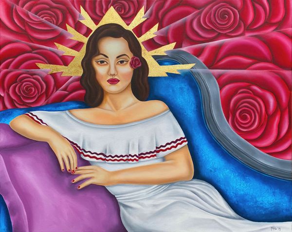 Woman with roses background sitting on a blue chaise.