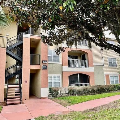 Exterior of a multi-story apartment building with stairs and balconies.
