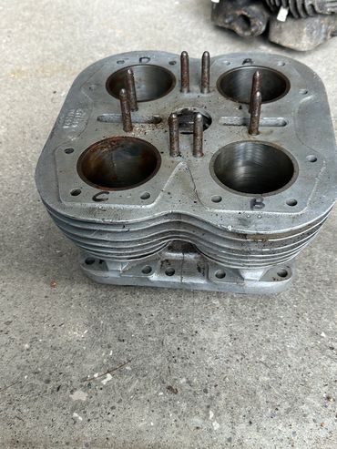 Metal engine cylinder head with four chambers.