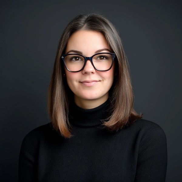 A woman wearing glasses and black sweater.