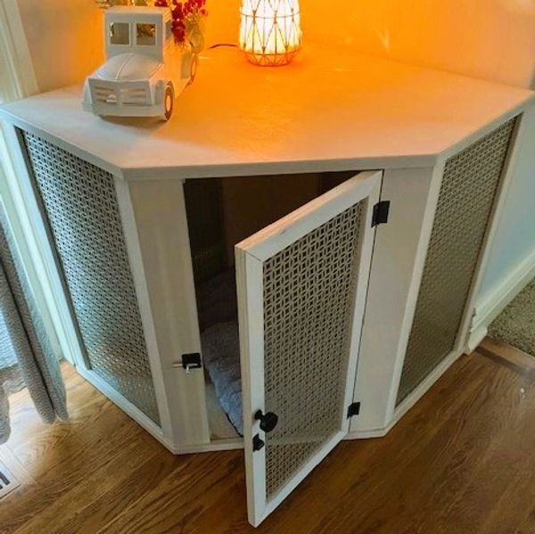 Hand crafted woodworking craftsmanship corner dog kennel with lamp and truck decoration on top.