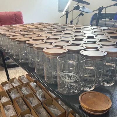Bulk order of glassware and each glass has a wood lid to avoid spills.