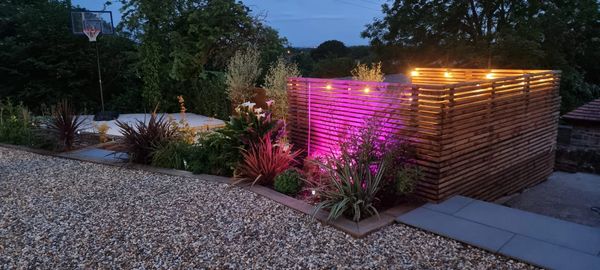 Landscaping & secluded fencing for seating area with fire-pit.