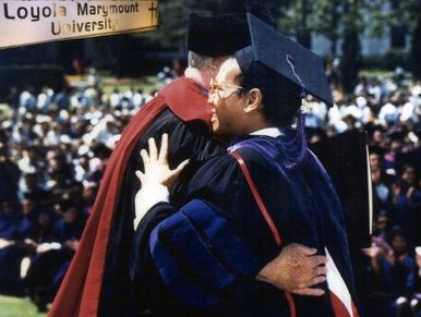 Olliei s congratulated by Loyola Marymount University President.