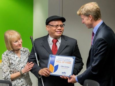 Ollie Cantos receives an award from Derek Shields and Rayna Aylward of the NDMC