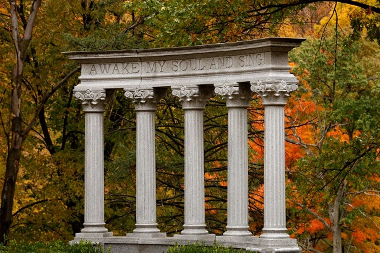 Photo of columns with text "Awake My Soul and Sing!"