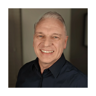 The therapist - a middle aged mad with a warm friendly smile, smartly dressed