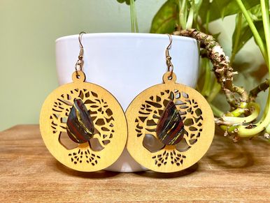 Handcrafted wooden earrings with intricate butterfly design.