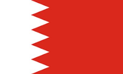 The national flag of Bahrain with white serrated band and red background.