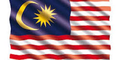 The national flag of Malaysia waving, featuring a crescent and star with red and white stripes.