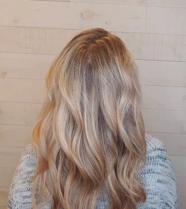 Long, wavy blonde hair viewed from the back.