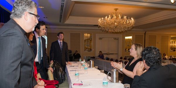 Jen Porro giving last minute reminders to Chiropractic education speakers and industry leaders.