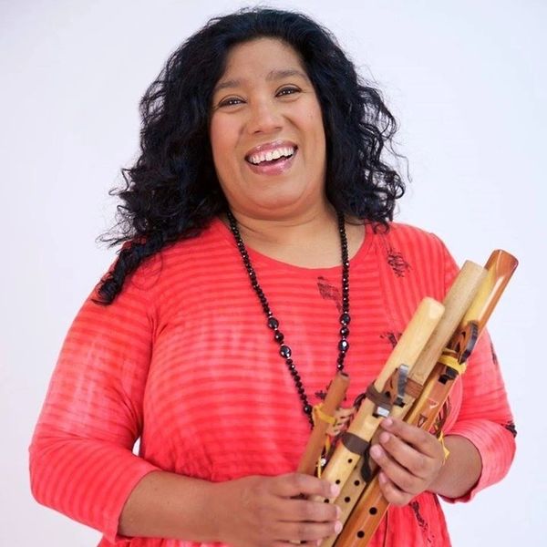 Jessica Valiente holding Native American flutes.