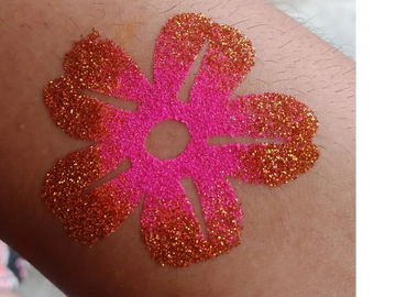 Neon pink and red Hawaiian glitter tattoo flower by Tu Meke Face Painting Gisborne New Zealand