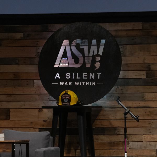 Stage setup with ASW logo and firefighter helmet.