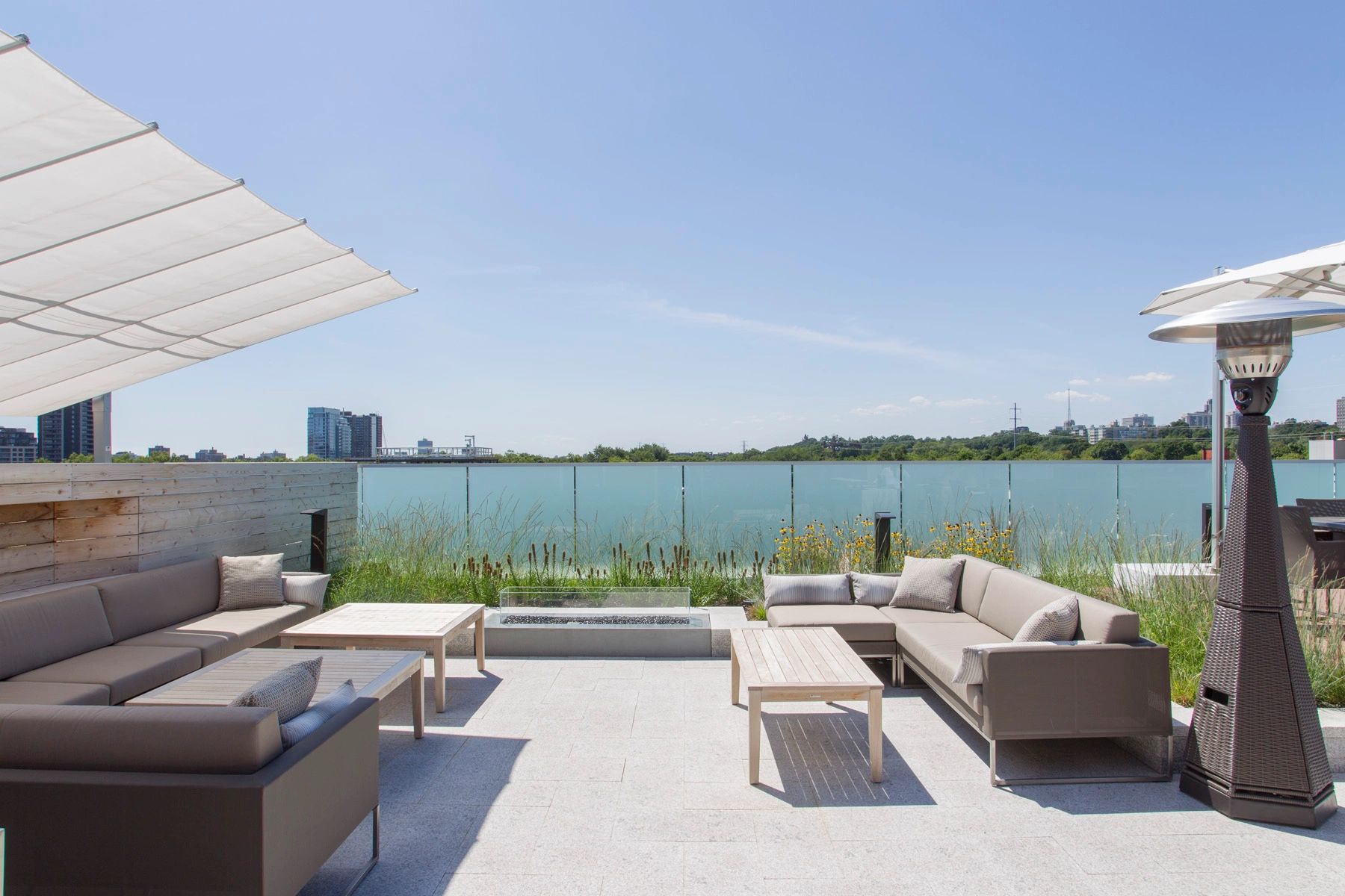 Modern outdoor patio with comfortable seating and clear blue sky.