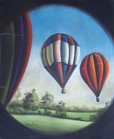 Looking through a camera lens at hot air balloons