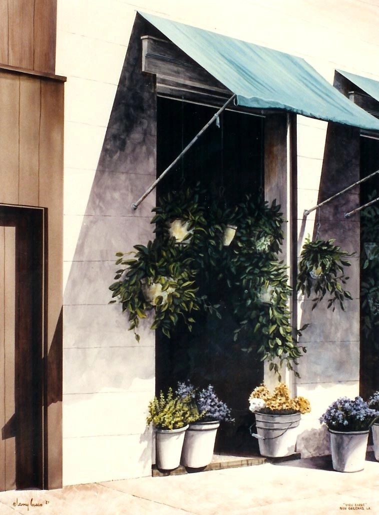 A Royal Street Shop with awning and flowers in buckets outside