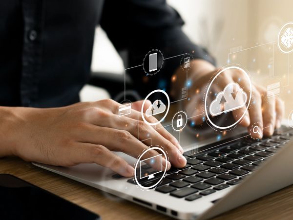 A person working on a laptop in cloud infrastructure