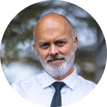 bearded man in shirt and tie smiling