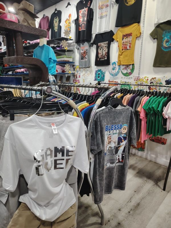 A vibrant clothing store with graphic tees and colorful apparel on display.