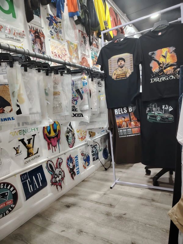 T-shirt display with various graphic designs in a trendy shop.