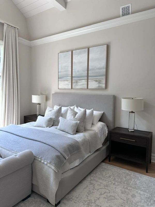 Modern bedroom with a gray bed and matching decor.