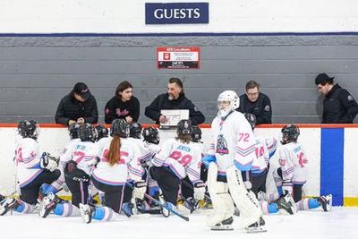 Hockey players on ice rink.