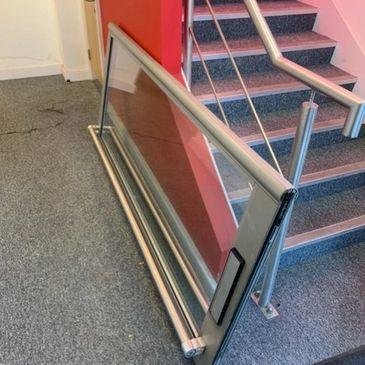 A commercial door sideways on the floor in process of being repaired