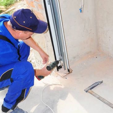 A man drilling into the side of a door bracket