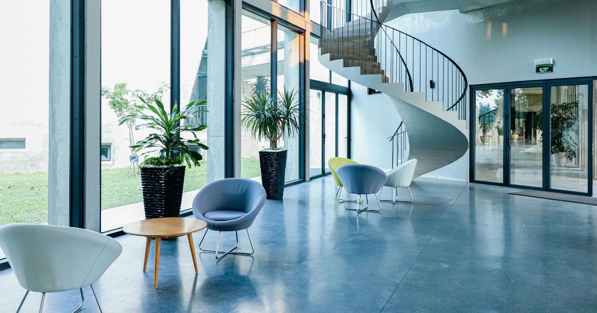 Modern interior with spiral staircase and seating area.