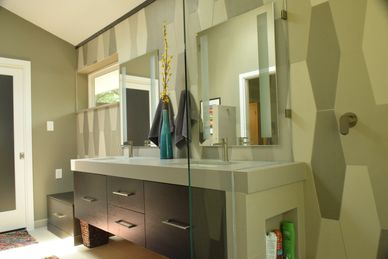 modern bath design with two sinks and two mirrors, a glass divider wall for the shower