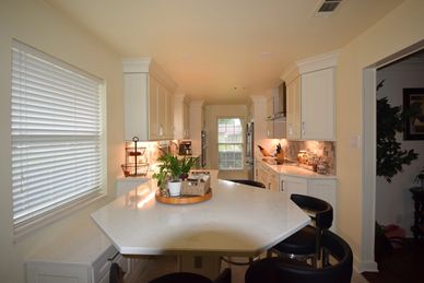 light kitchen and dining area with a large table