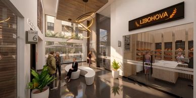 Modern shopping area with bakery and seating under natural light.