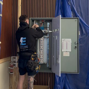 Licensed electrician working on a switchboard panel in Melbourne