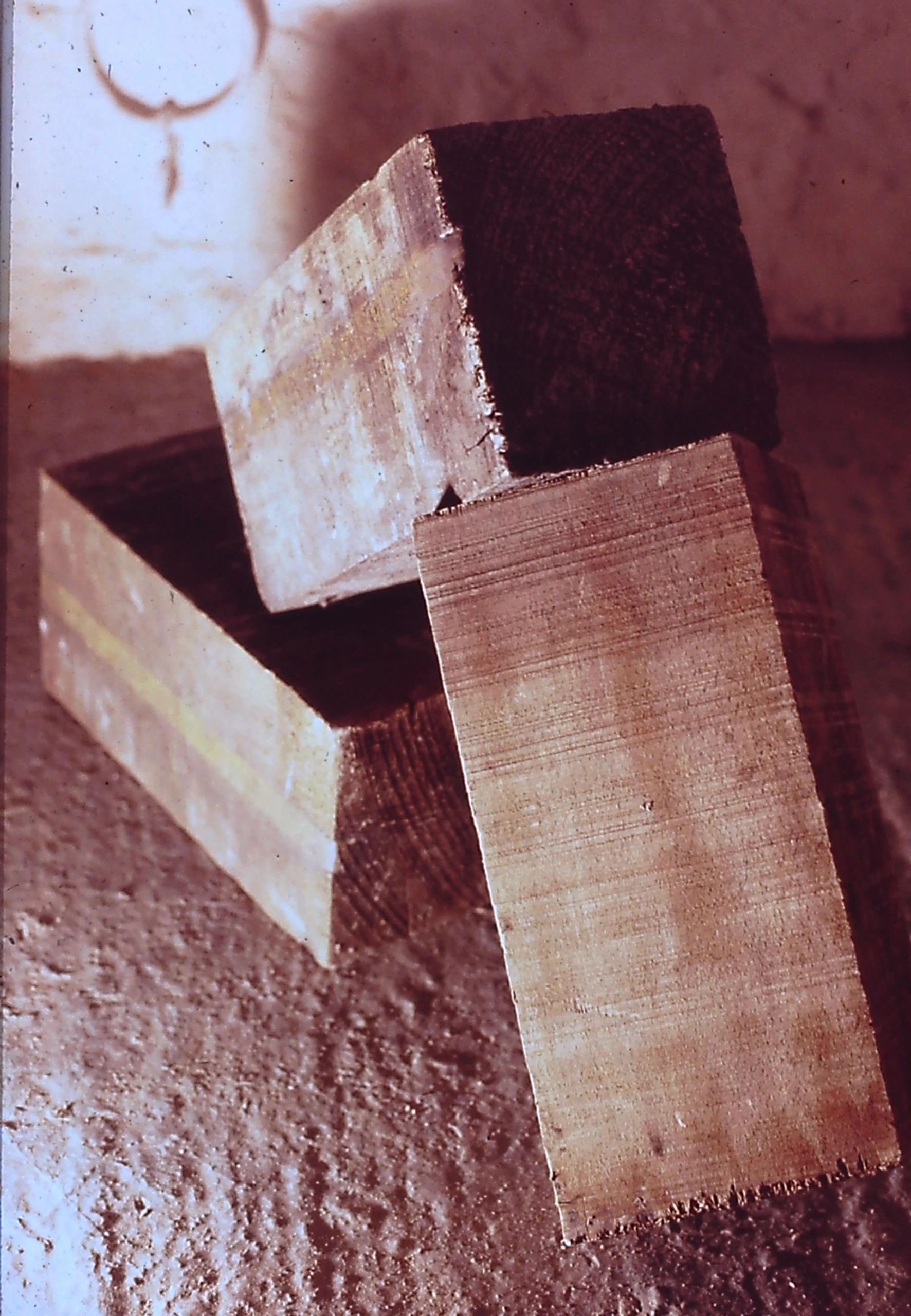 alt="Stacked wooden blocks in shadow"