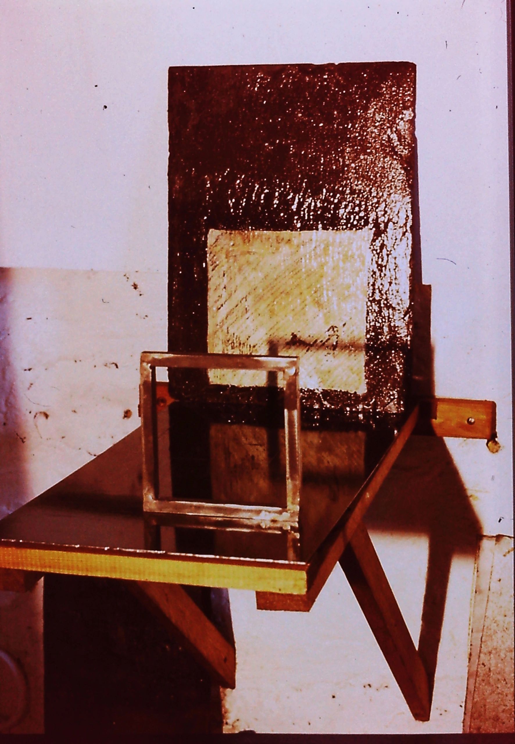 alt="Light behind steel slate and square shape"